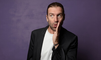 feeling shocked and astonished holding face to hand in disbelief with mouth wide open