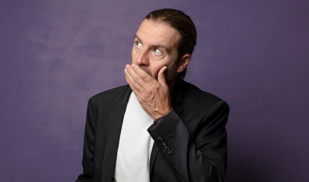 covering mouth with hands with a shocked, surprised expression, keeping a secret or saying oops