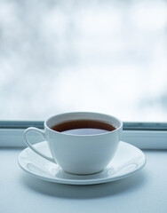 Cup with tea on the background of the winter landscape.