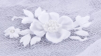 Delicate white flower applique on sheer fabric.