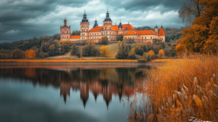 Fototapeta premium Autumnal castle reflecting on a calm lake.