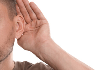 Fototapeta premium Man showing hand to ear gesture on white background, closeup