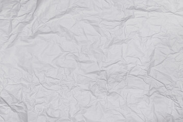 Background or pattern of wrinkled white rectangular paper with soft texture