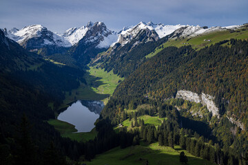 swiss mountains landscape with lake and peaks of alpstein in autumn