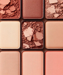 Fototapeta premium Close-up of warm beige and pink eyeshadow pigments palette
