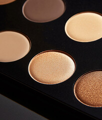 Close-up of beige and brown eyeshadow pigments palette