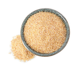Raw wheat groats in bowl isolated on white, top view