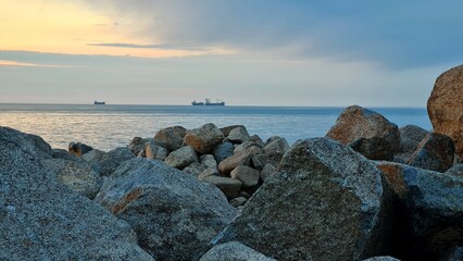Large stones on the seashore, the sea can be seen in the distance