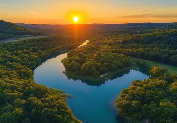 Serene Aerial View of a Meandering River at Sunset Surrounded by Lush Green Forests and Colorful Sky Capturing Nature's Tranquility and Beauty