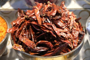 A bowl with pods of dried chili peppers on bazaar in Deira, Dubai, UEA