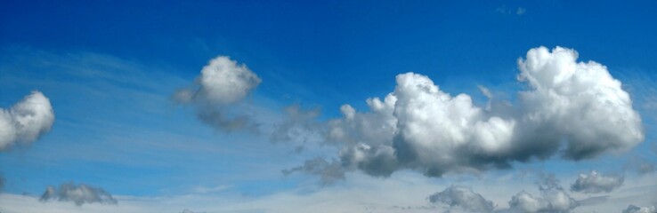 Blue sky with white Cumulus clouds - natural air space panorama. Topics: weather, meteorology, atmosphere, nature, background