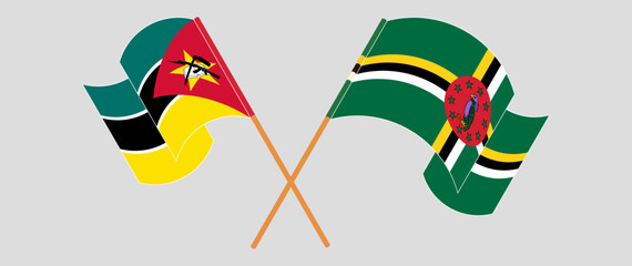 Crossed and waving flags of Mozambique and Dominica. Vector illustration