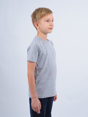 T-shirt design concept. Teen boy in blank gray t-shirt, isolated on white background.