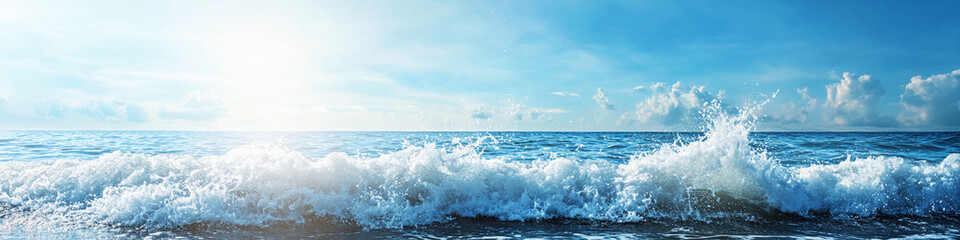 Fototapeta premium Waves crash on a sunny shoreline with clear blue skies