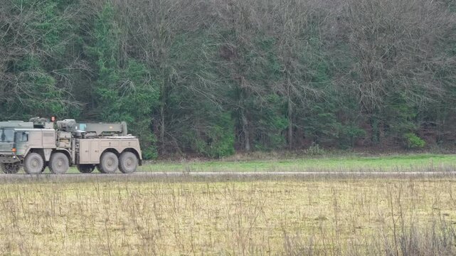 British army MAN HX58 9 tonne 6x6 Medium Mobility logistics vehicle followed by MAN SVR (Support Vehicle Recovery) 8x8 Trucks