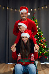 Fototapeta premium Happy family at christmas with santa claus hat