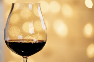 a glas of wine and christmas lights