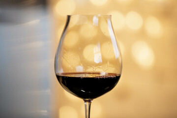 a glas of wine and christmas lights