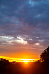 Sunrise with intense natural orange lights and idyllic dramatic scenery