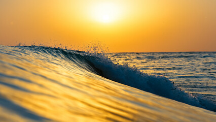 Inside a breaking wave. A split moment of beauty. Sunset.