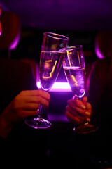 An Elegant Hand Holding a Glass of Exquisite White Wine While in a Luxurious Car Setting