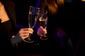 An Elegant Hand Holding a Glass of Exquisite White Wine While in a Luxurious Car Setting