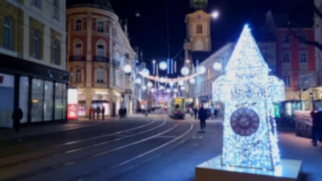 Blurred people walking on famous Herrengasse street with beautiful Christmas decorations and lights, at night. Timelapse, 4K