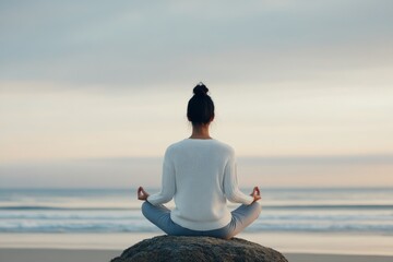 Fototapeta premium Meditation practice by the ocean on a cloudy day for relaxation and mindfulness