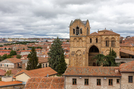 Avila (Spain) cityscape with Basilica of San Vicente romanesque architecture church and tiled rooftops of old medieval buildings, view from Wall of Avila.
