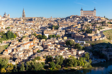 Naklejka premium Toledo (Spain), landscape of the medieval city with Alcazar of Toledo, Toledo Cathedral, churches and residential buildings on a hill seen from Mirador del Valle.