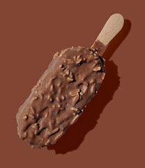 Chocolate ice cream on a stick on brown background