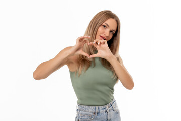 A woman expressing love by forming a heart shape with her hands against a plain white background,...