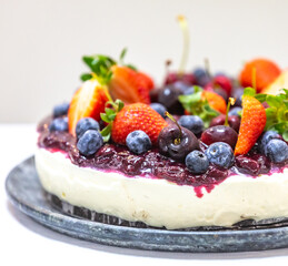 Traditional Christmas red fruit cheesecake with creative and luxurious decoration