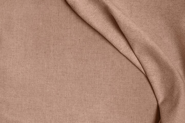 Soft elegant warm mocha brown color background with empty copy space, natural linen fabric with abstract folds in trendy color of 2025