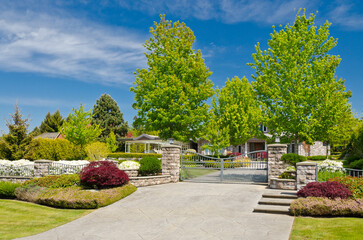 Entrance of grey painted luxury house in summer with stair steps and nice landscape in Vancouver,...