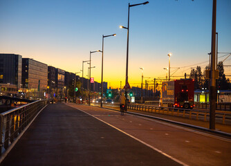Fototapeta premium Amsterdam, Netherlands—Oct 05, 2024: the piet Heinkade street at dawn break, orange