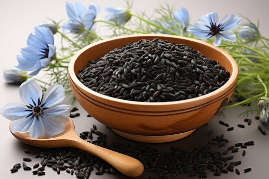 Black cumin seeds with nigella sativa flower on white background,  
