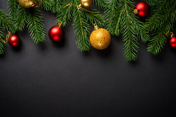 Black christmas flat lay background. Christmas tree with holidays decorations at black background.