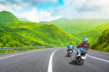 motorcycle drive on the europe mountain road landscape in summer. motorbike driver is speeding along the travel road. Riding freely on the highway in green nature scenery. europe travel road.