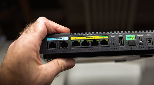 Paris, France - Nov 19, 2021: Close-up of the back panel of the Orange Livebox 5 router, showing labeled Ethernet, USB, and fiber ports, designed for efficient and versatile home internet connectivity
