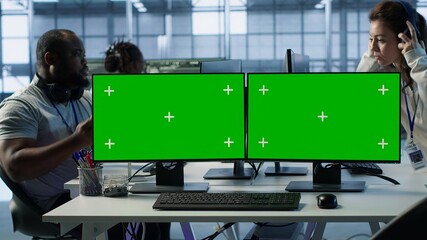 Close up of multi monitor isolated screen computer in data center used for supervising server rows...