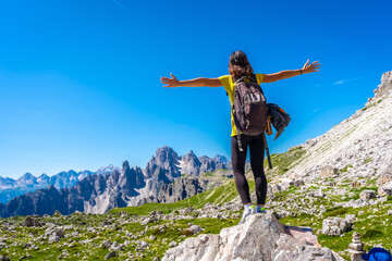 Tourist enjoying freedom and pristine nature in the dolomites, tre cime di lavaredo, italy