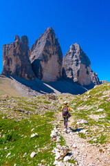 Tourist hiking on trail near tre cime di lavaredo, dolomites, italy