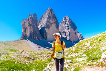 Tourist hiking on the tre cime di lavaredo trail in the italian dolomites in summer