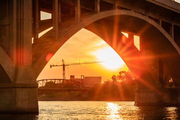 A bridge with a sun shining through it