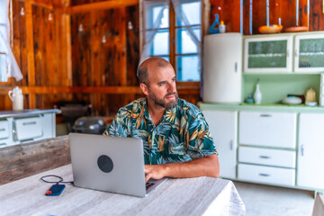 Freelancer working remotely from rustic cabin enjoying nomadic lifestyle