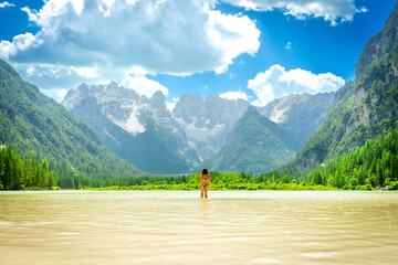 Tourist enjoying summer vacation in the dolomites, lago di landro, italy