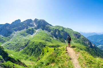 Tourist hiking along the scenic trails of the giau pass in the italian dolomites