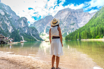 Tourist enjoying breathtaking view of lake braies in dolomites, italy, during summer vacation