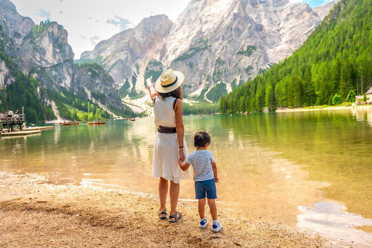 Mother and son admiring lake braies in the dolomites